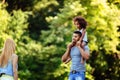 Portrait of young father carrying his daughter on his back Royalty Free Stock Photo