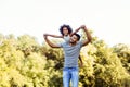 Portrait of young father carrying his daughter on his back Royalty Free Stock Photo