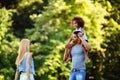 Portrait of young father carrying his daughter on his back Royalty Free Stock Photo