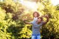 Portrait of young father carrying his daughter on his back Royalty Free Stock Photo