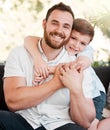 Like father like son. Portrait of a young father and son bonding together at home. Royalty Free Stock Photo