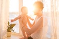 Portrait of father standing near the window with baby Royalty Free Stock Photo