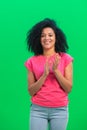 Portrait of young female African American looking at camera and clapping her hands happily. Black woman with curly hair Royalty Free Stock Photo