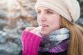 Woman protecting lips with lip balm on snowy day.