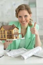 Portrait of young female architect holding model of house Royalty Free Stock Photo