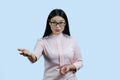 Portrait of a young female asian boss in glasses is giving you an order.