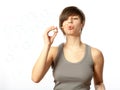 Portrait of a young female blowing soap bubbles Royalty Free Stock Photo