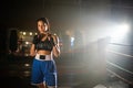 Portrait of young female boxer posing for camera in gym Royalty Free Stock Photo