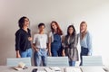 Portrait Of Young Female Business Team Standing By Table In Meeting Room In Modern Workspace Royalty Free Stock Photo