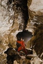 A portrait of a young female caver exploring the cave Royalty Free Stock Photo