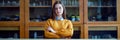 Portrait of young female college student in chemistry class, sitting behind the desk with crossed arms. Royalty Free Stock Photo