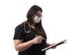 Portrait of a young female doctor in black uniform wearing a mask, holding a note pad, isolated on white background Royalty Free Stock Photo