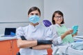 Portrait of female dentist with woman patient sitting in dental chair Royalty Free Stock Photo