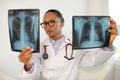 Portrait of young female doctor examining radiological images