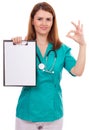 Portrait of a young female doctor holding a clipboard and showing ok sign