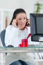 Portrait young female doctor on phone at office Royalty Free Stock Photo