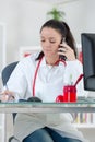 Portrait young female doctor on phone at office Royalty Free Stock Photo