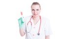 Portrait of young female doctor smiling and holding a syringe Royalty Free Stock Photo