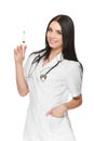 A portrait of a young female doctor smiling with a syringe in her hand