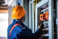 Portrait of a young female electrician working in a power plant, Female commercial electrician at work on a fuse box, adorned in Royalty Free Stock Photo