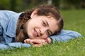 portrait of young female while lying in spring green garden Royalty Free Stock Photo