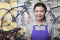 Portrait of young female mechanic in bicycle store, Beijing