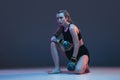 Portrait of young female MMA fighter isolated on blue background in neon