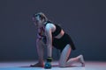 Portrait of young female MMA fighter isolated on blue background in neon