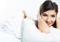 Portrait of young female model lying in bed.