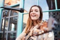 Portrait Of Young Female Musician Busking Playing Acoustic Guitar And Singing Outdoors In Street Royalty Free Stock Photo