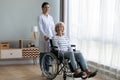 Caring female nurse support disabled senior woman patient Royalty Free Stock Photo