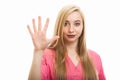 Portrait of young female nurse wearing scrubs showing number five Royalty Free Stock Photo