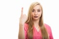 Portrait of young female nurse wearing scrubs showing number one Royalty Free Stock Photo