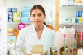 Portrait of a young female pharmacist standing behind the counter of a pharmacy Royalty Free Stock Photo