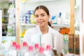 Portrait of a young female pharmacist standing behind the counter of a pharmacy Royalty Free Stock Photo