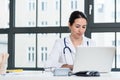 Portrait of young female physician working on laptop in the office Royalty Free Stock Photo