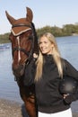 Portrait of young female rider and horse Royalty Free Stock Photo