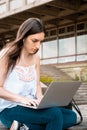 Young student using laptop outdoors Royalty Free Stock Photo