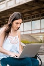 Young student using laptop outdoors Royalty Free Stock Photo