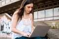 Young student using laptop outdoors Royalty Free Stock Photo