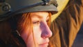 Portrait of young female ukrainian army soldier. Sad emotion on face of girl in military helmet during war in Ukraine