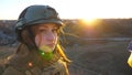 Portrait of young female ukrainian army soldier. Sad emotion on face of girl in military helmet during war in Ukraine