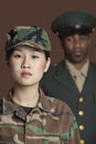 Portrait of young female US Marine Corps soldier with officer in the background