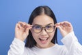 Portrait of young female wearing glasses over blue background studio  healthcare concept Royalty Free Stock Photo