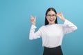 Portrait of young female wearing glasses over blue background studio  healthcare concept Royalty Free Stock Photo