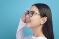 Portrait of young female wearing glasses over blue background studio  healthcare concept Royalty Free Stock Photo