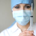 Portrait of a young female woman holding a syringe Royalty Free Stock Photo