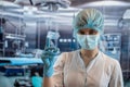 Portrait of young female woman surgeon wearing protective cloth surgical mask in operation room Royalty Free Stock Photo