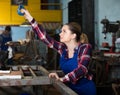 Portrait of young female working with lift hook