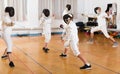 Young fencers training with coach